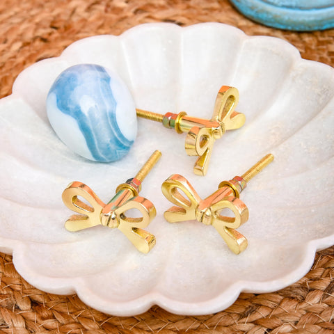 Handmade detail of Perilla Home brass bow knob highlights craft