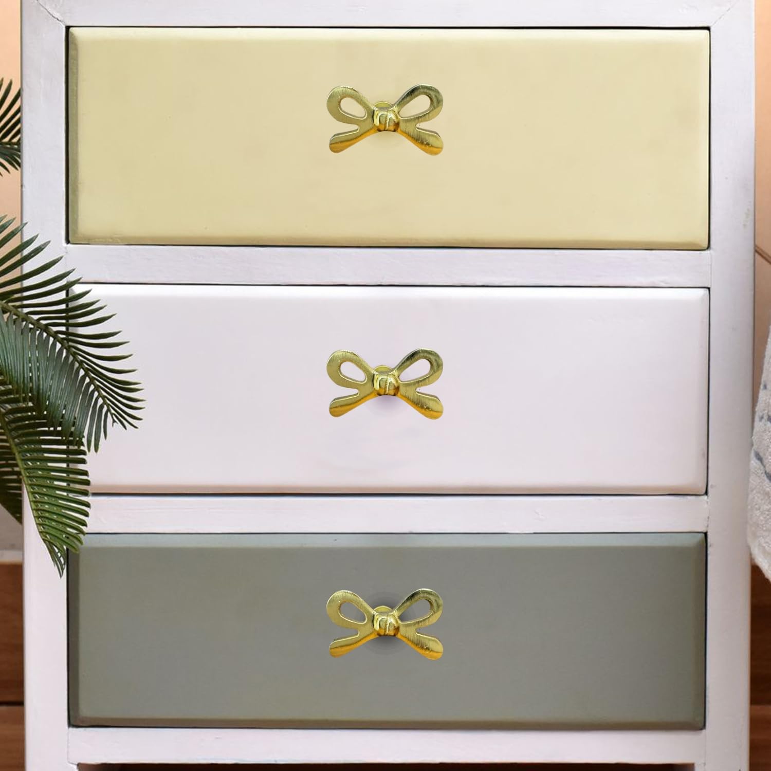 Metallic glow of Perilla Home bow knob enhances vintage décor