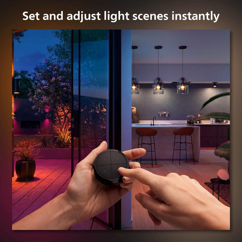 Philips Hue switch mounted on adhesive wall plate for flexible placement.