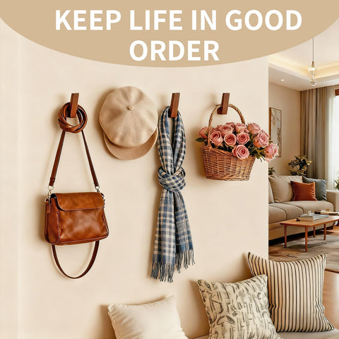 PinEther hidden-mount walnut hooks providing minimalist, seamless wall lines.