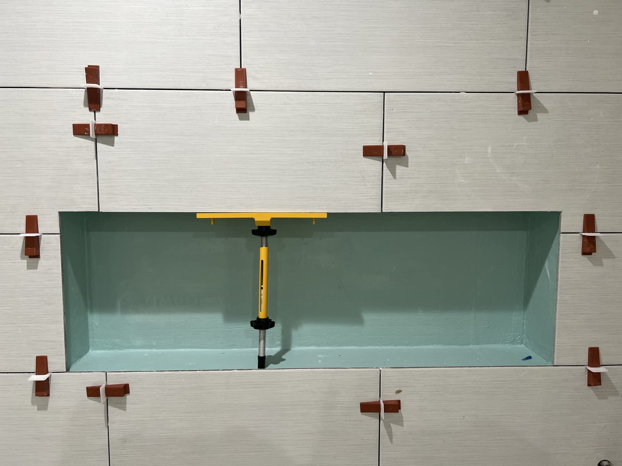 Planum holding plate highlights adjustable fit for varied niche depths.