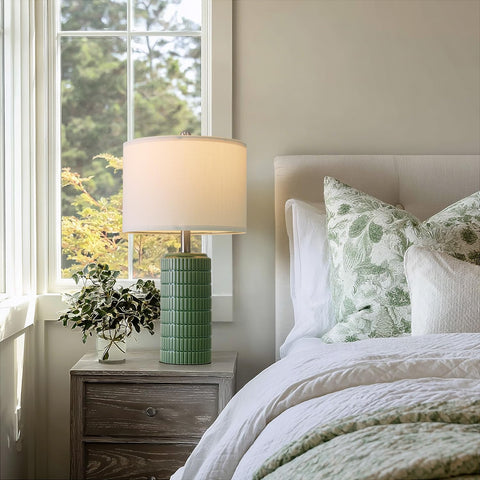 PoKat green ceramic lamps on living room end table brighten the space.