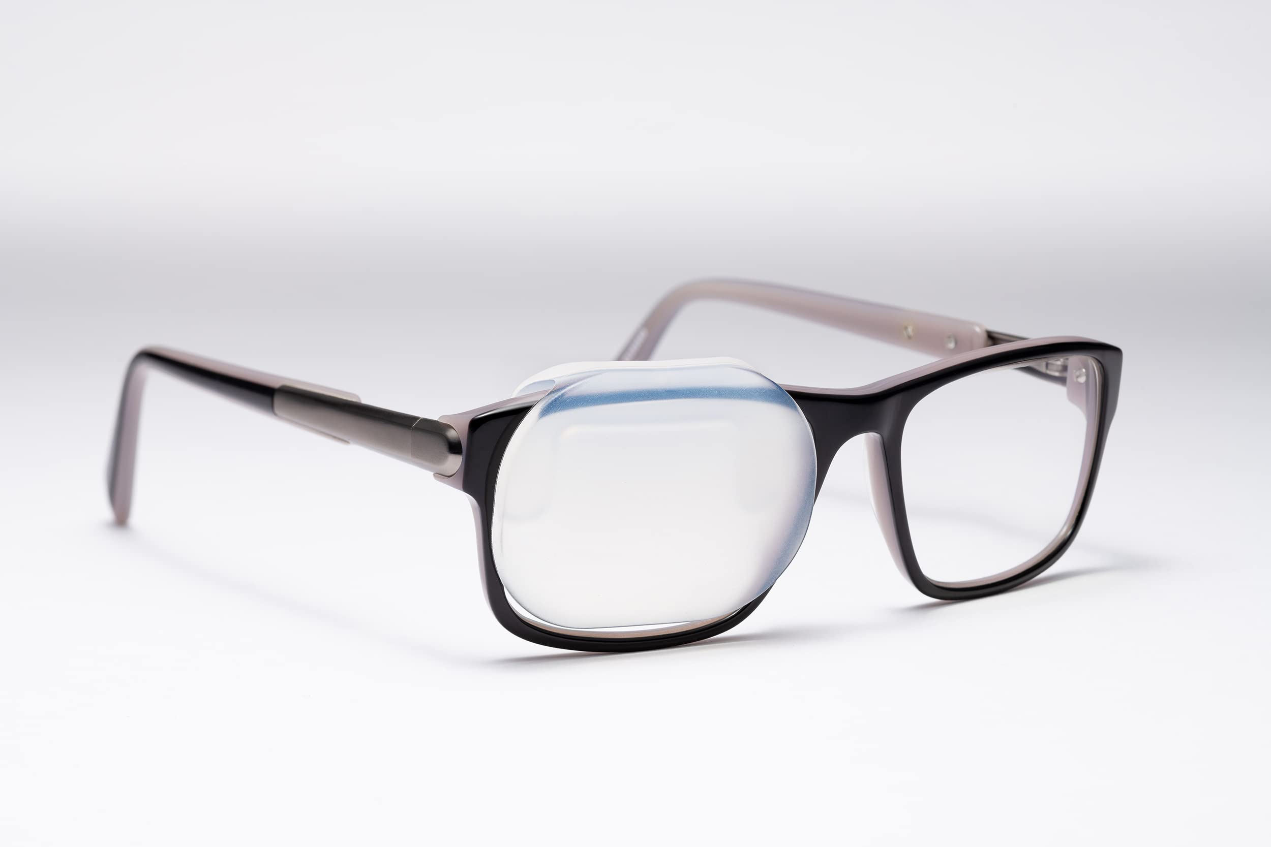 Precision Vision OPTISHIELD silicone occluder attached to glasses enables hands-free eye occlusion.