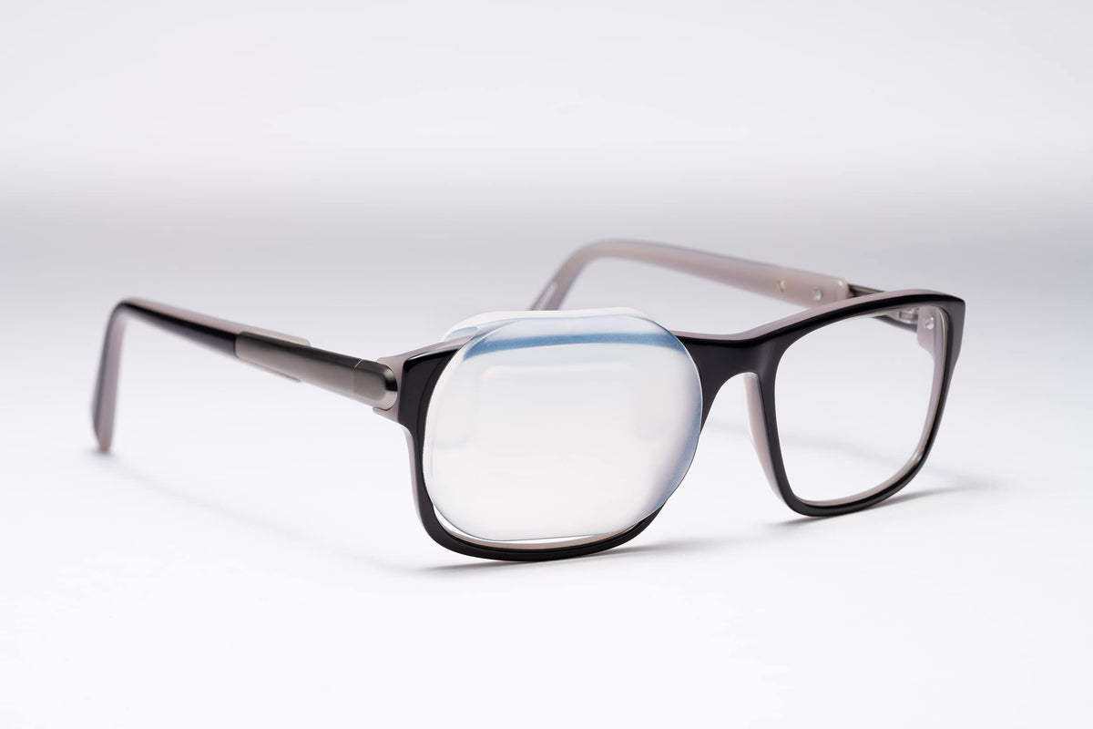 Precision Vision OPTISHIELD silicone occluder attached to glasses enables hands-free eye occlusion.