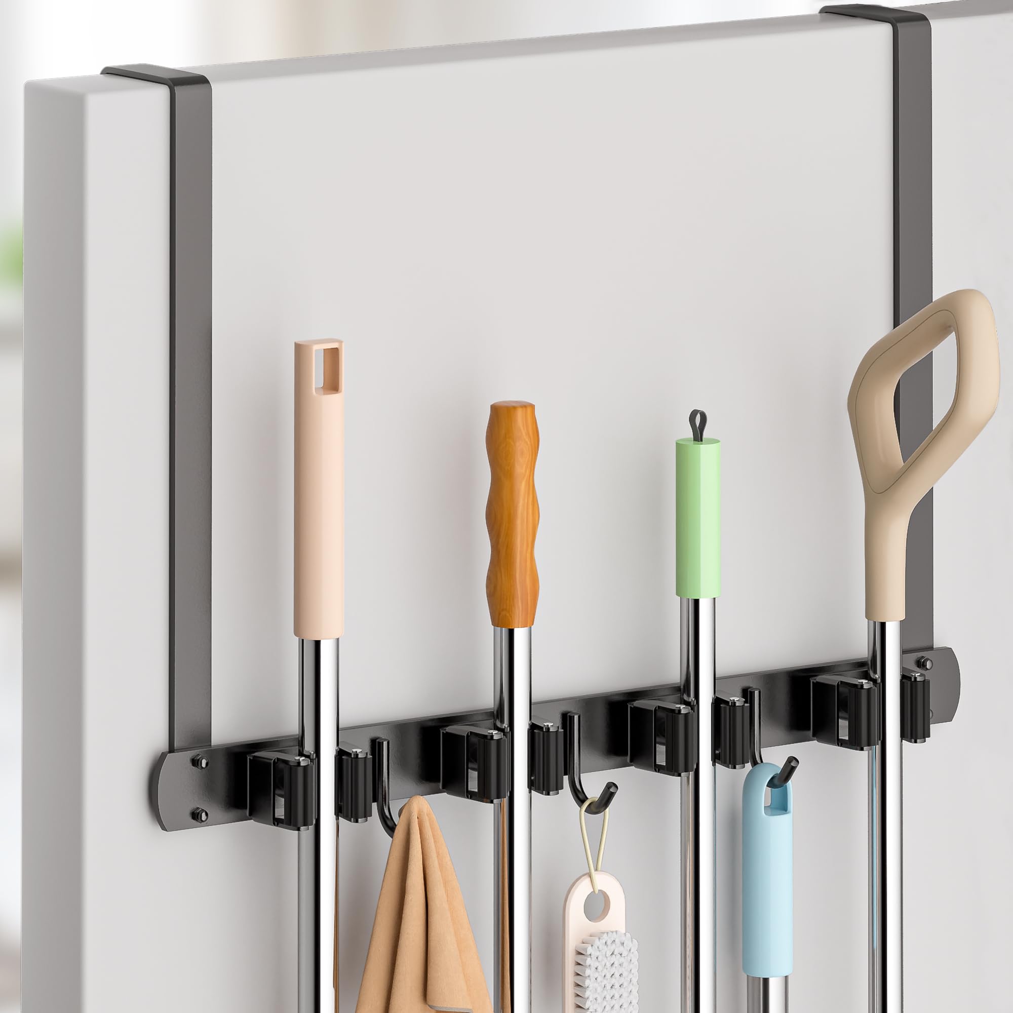 PrimZooty over-the-door broom holder primed for space-saving organization behind a door