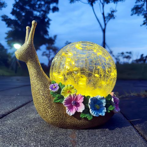 QCF Solar Snail Garden Light glows softly for outdoor ambiance.