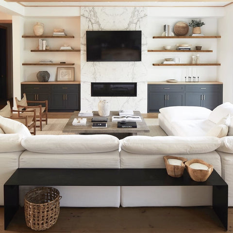 Living room setup showing QEEIG shelves with books and decor.