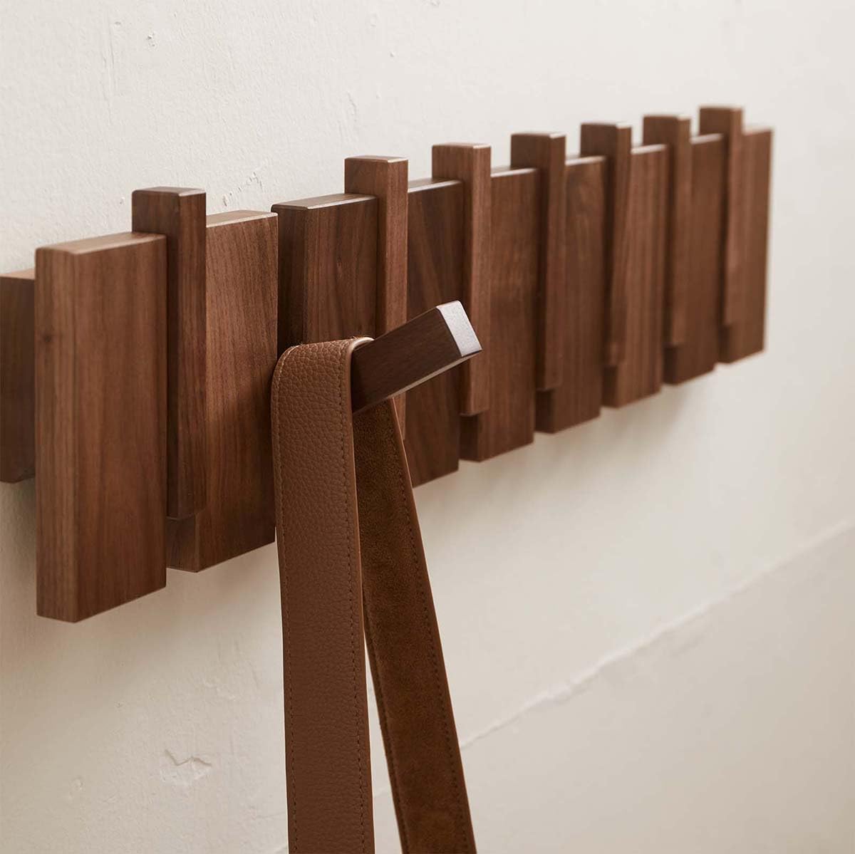Quellance eight flip-down hooks organize coats and bags for busy households.
