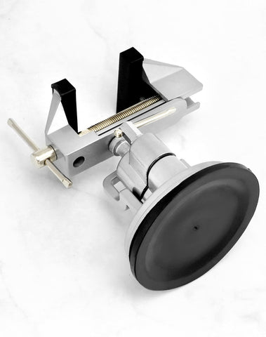 QWORK vacuum base vise shown attached to a smooth surface for versatile mounting.
