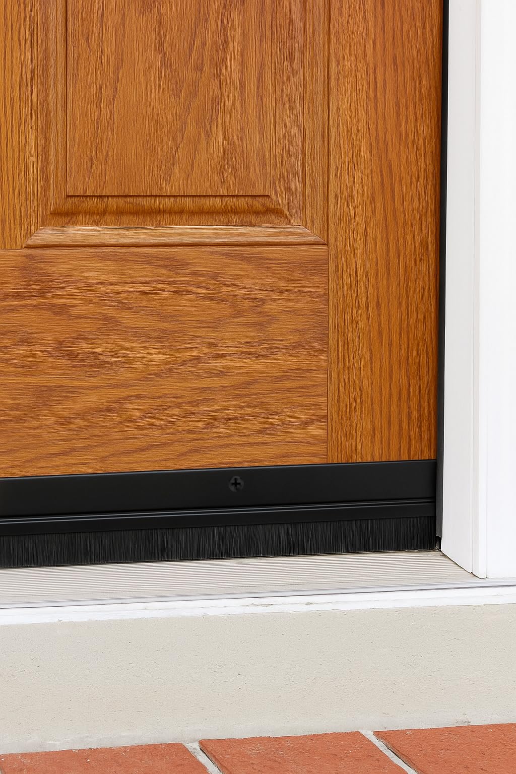 Randall Manufacturing Co. black-trim door sweep complements modern doors while blocking debris.