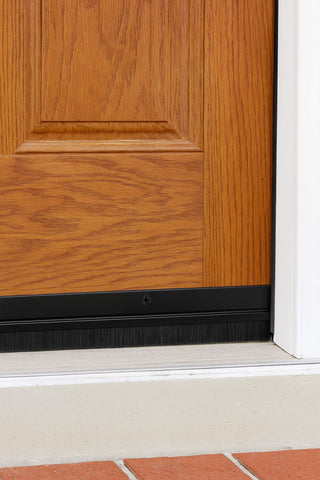 Randall Manufacturing Co. black-trim door sweep complements modern doors while blocking debris.
