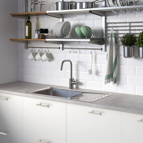 Ravinte cabinet hardware complements nickel appliances for cohesive look.