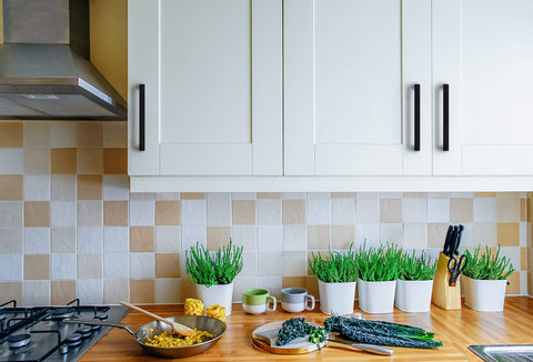 Ravinte drawer pulls on a wood kitchen cabinet demonstrates versatile style.