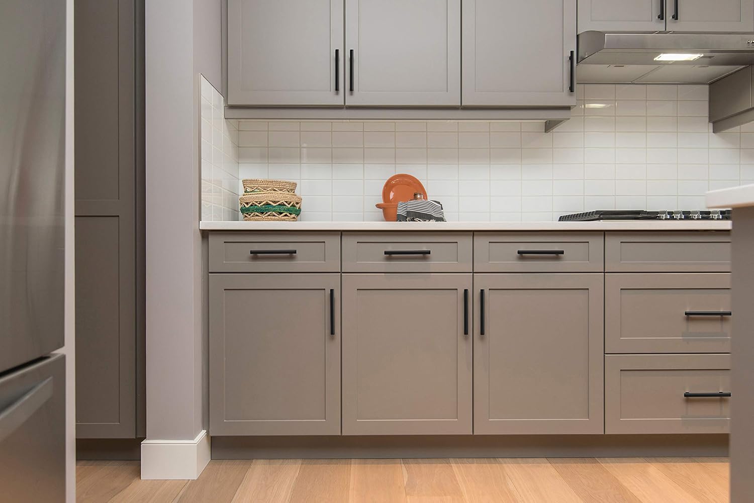 Matte black Ravinte pull shown on a drawer for a monochrome look.