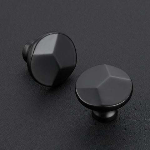 Ravinte matte black round knob on a sleek cabinet drawer