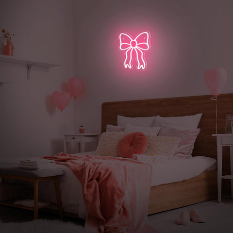 Retisee Pink Bow neon sign lighting a beauty room for a warm backdrop.
