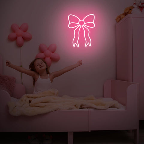 Retisee Pink Bow neon sign used as a playful party backdrop with color.