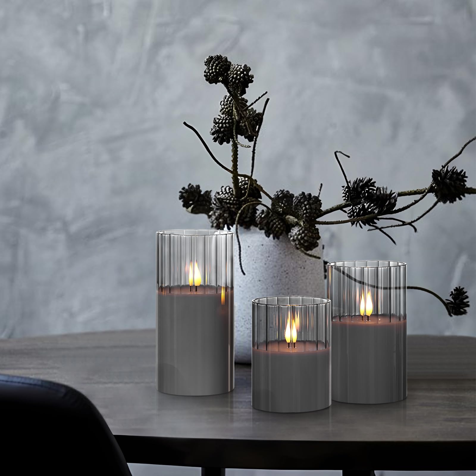 Glossy gray glass reflects candlelight for a subtle glow.