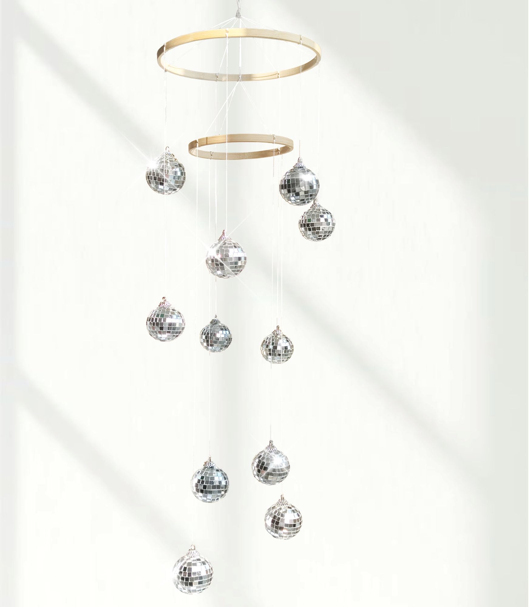 Rodudu disco ball mobile with spiral spinner casting dynamic reflections for indoor parties.