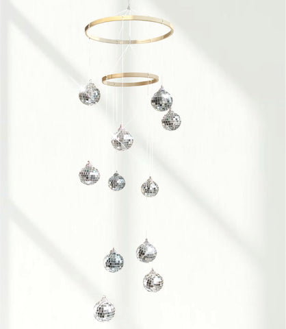 Rodudu disco ball mobile with spiral spinner casting dynamic reflections for indoor parties.