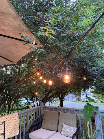 Rolay amber tinted glass bulb adding cozy tone to deck