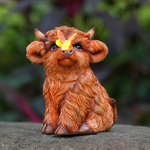 Roundot Highland Cow solar light statue lights outdoor spaces at dusk