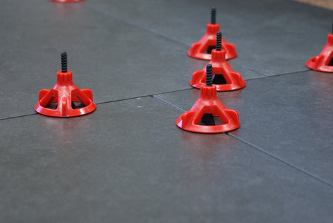 RTC Spin Doctor cap being tightened with one hand on large-format tile