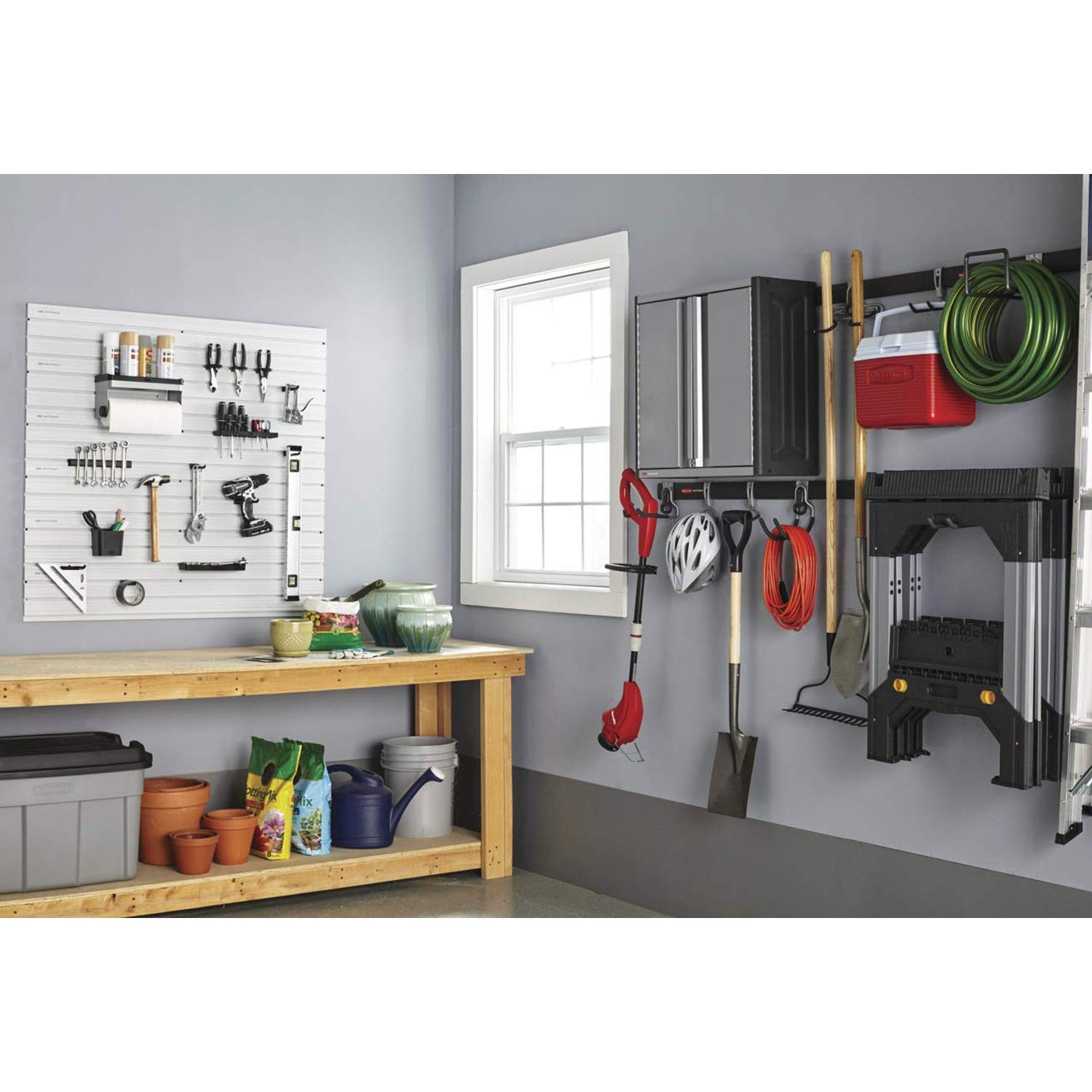 Ladders, ropes, drills, and tools neatly organized in one area.