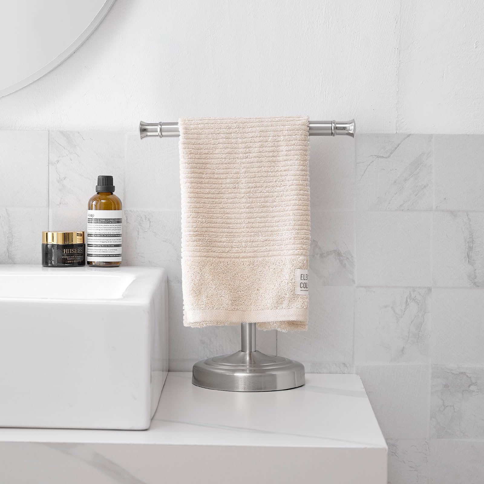 RUMOSE towel stand in a bathroom setting beside the sink.