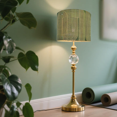 Geometric green pattern on the Rustic Bamboo Drum lamp shade diffuses soft light.
