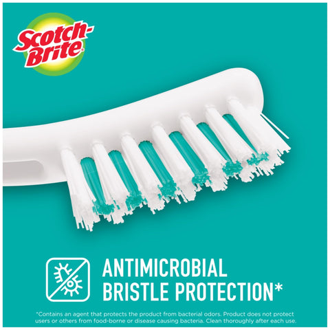 Scotch-Brite grout brush reaching tight spaces between tiles and fixtures.