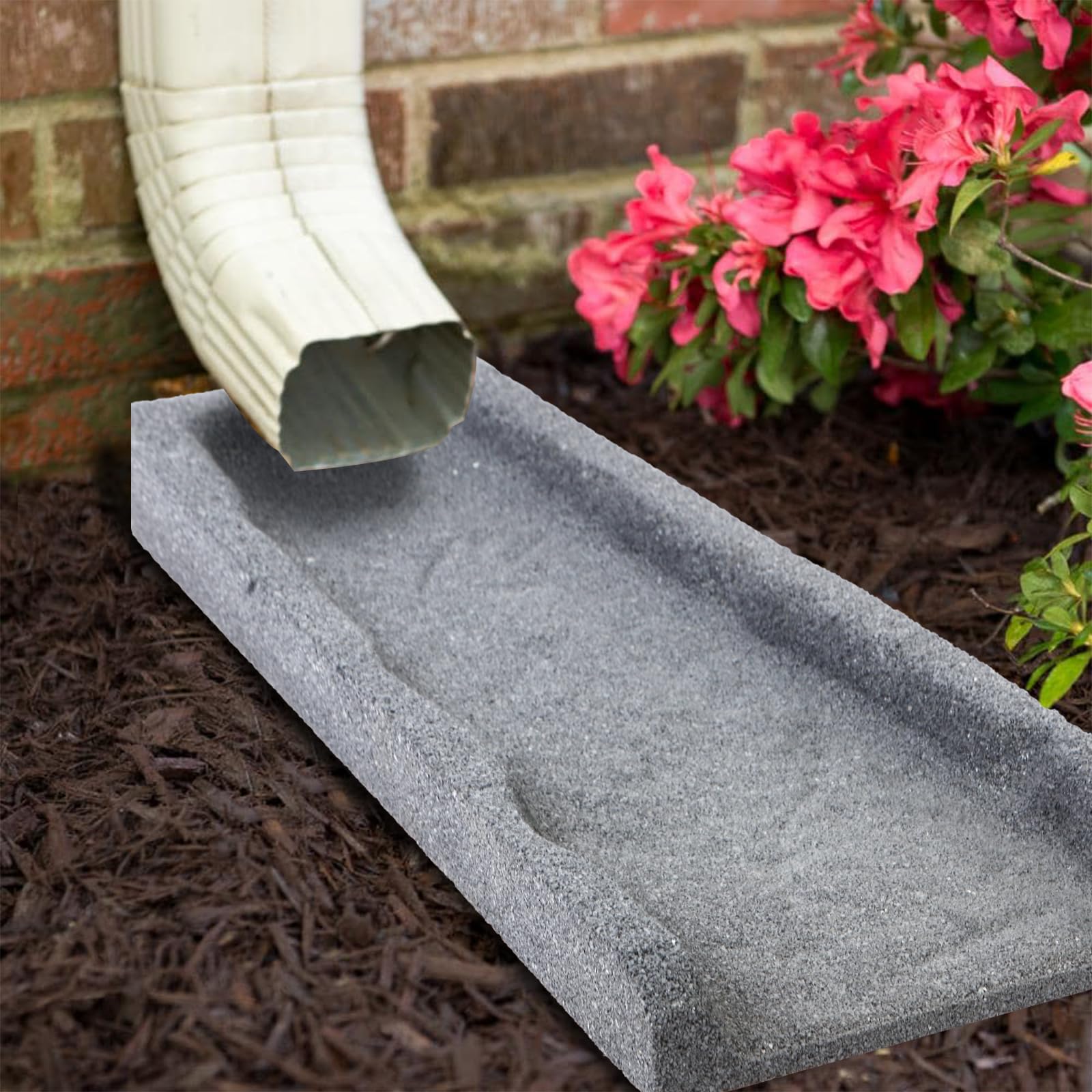 Sekcen splash blocks on a driveway edge reduce erosion around the yard.