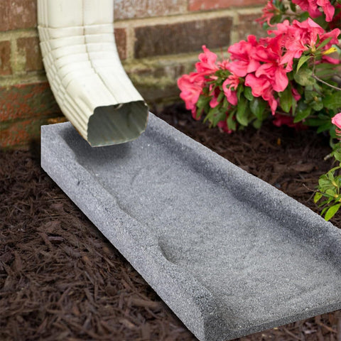 Sekcen splash blocks on a driveway edge reduce erosion around the yard.