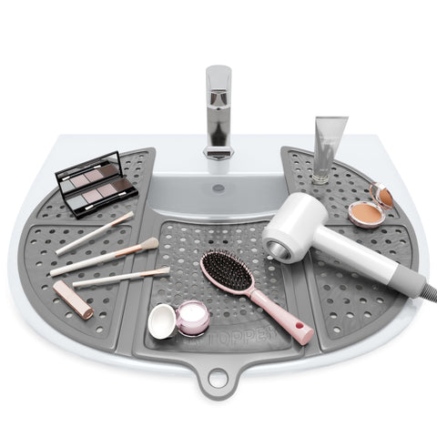 Sink Topper foldable silicone mat protecting bathroom surfaces from heat and spills.