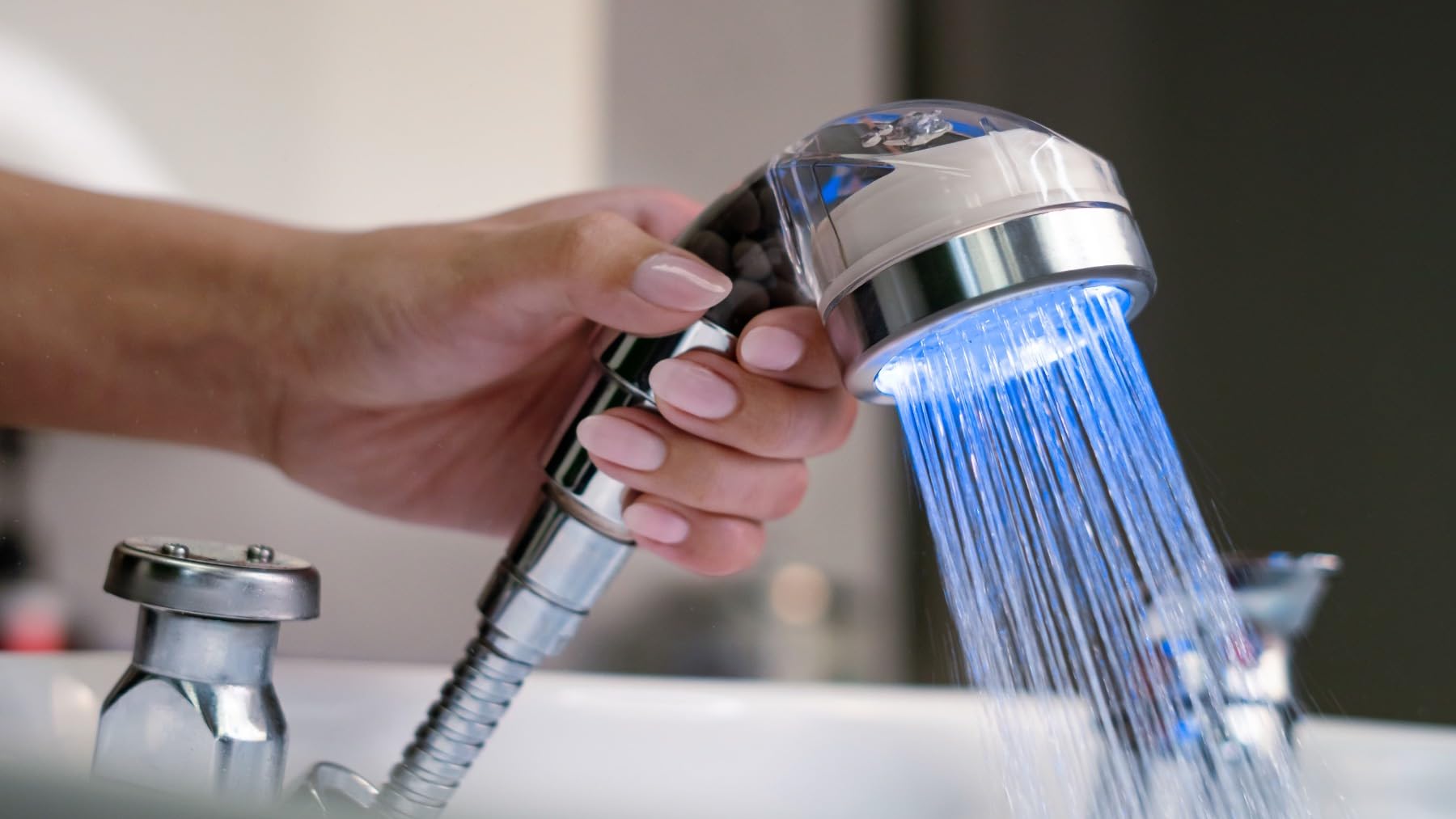 Socila LED sprayer head close-up shows color-changing LEDs for salon ambiance.