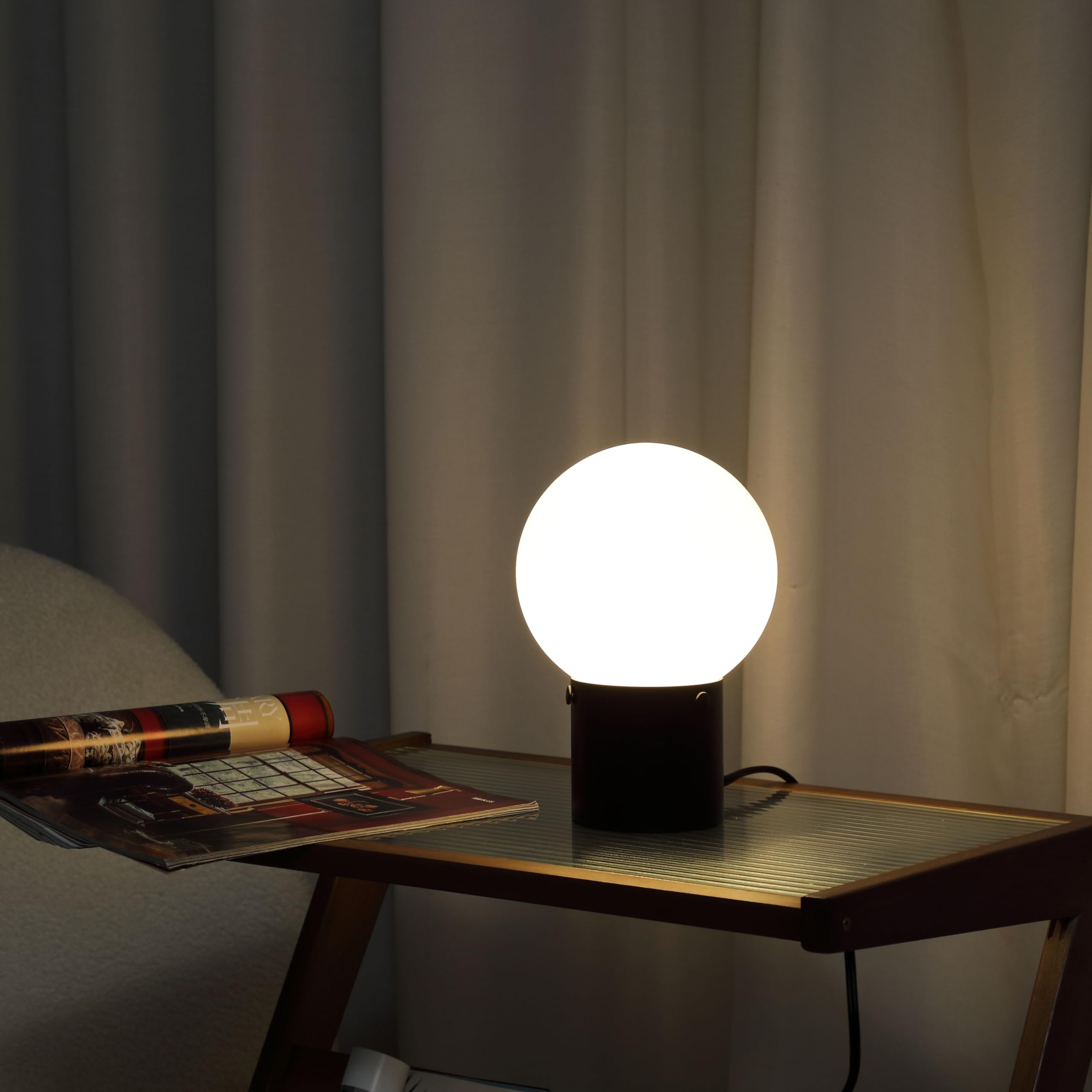Somniferous table lamp black metal base adds durable, modern style to any room.