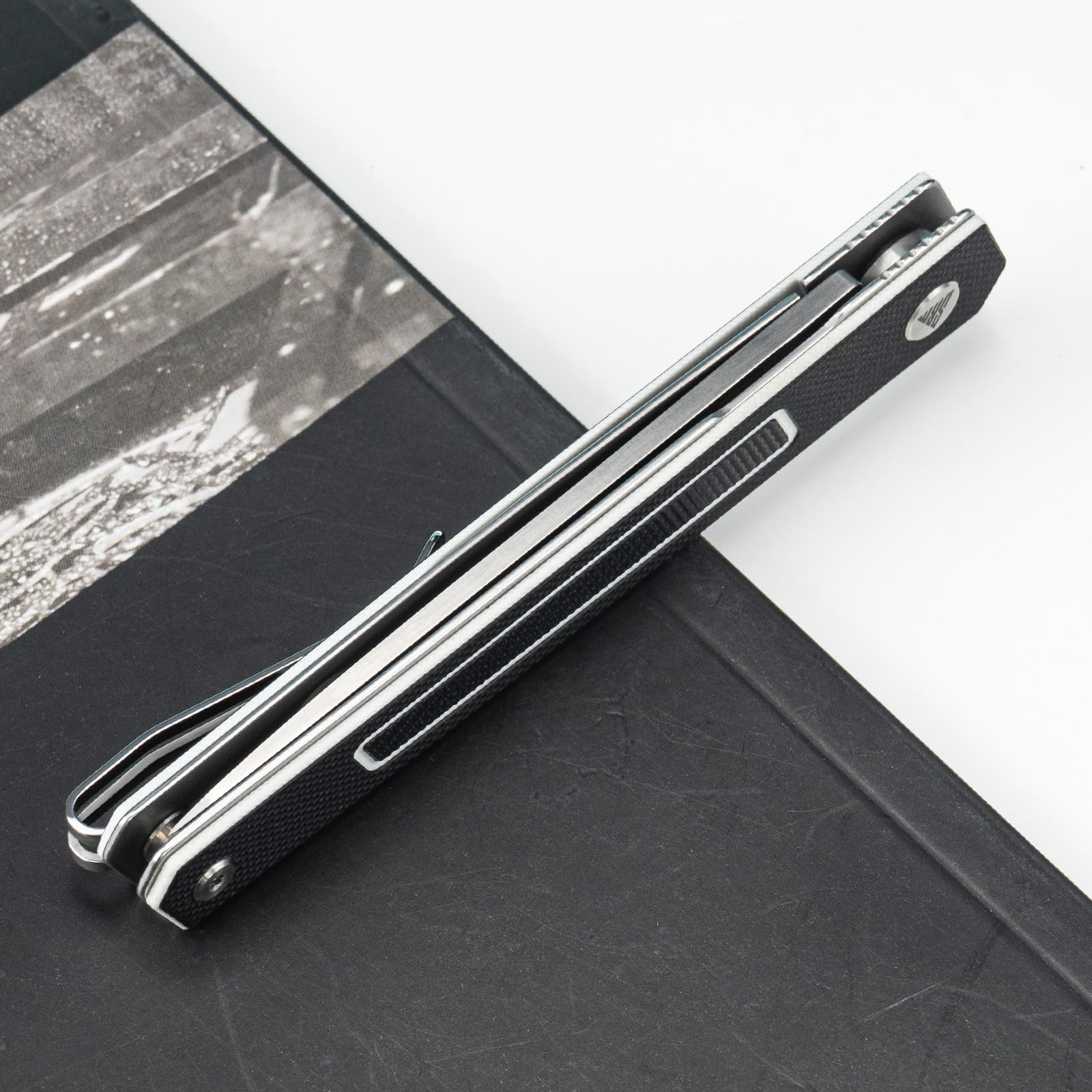 SRM folding knife dual jimping grip for secure handling.