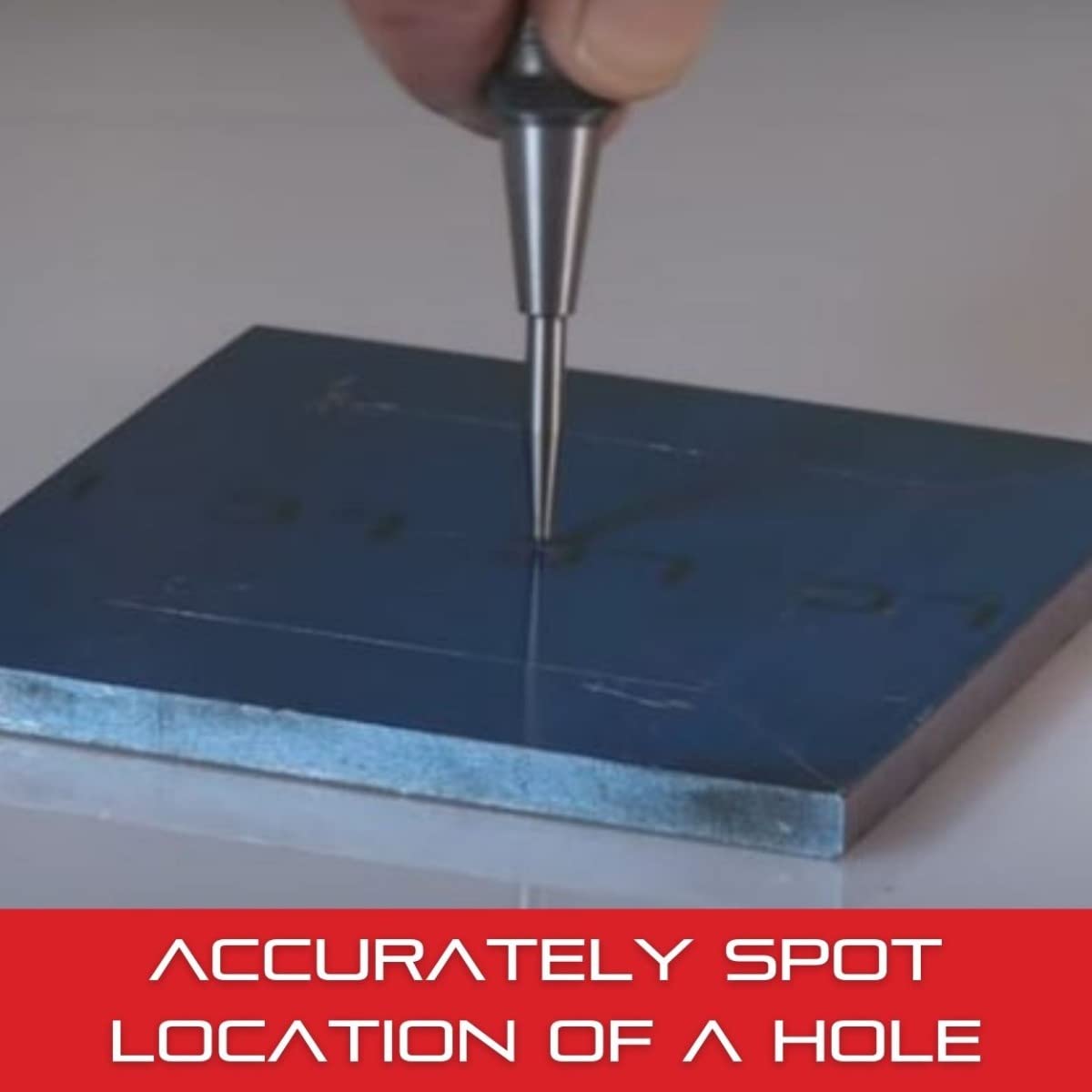 Center punch in use creating a spot for drilling.