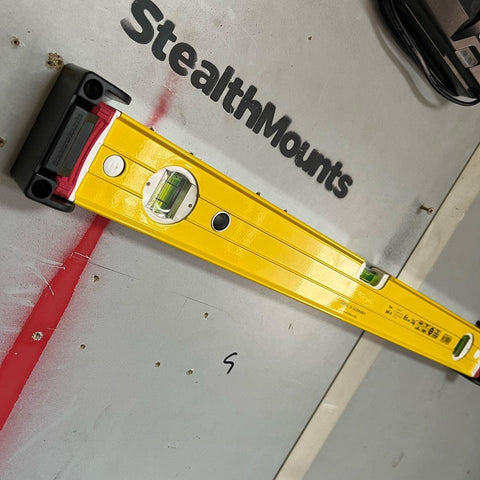StealthMounts level holder in use on a workbench keeps levels within reach