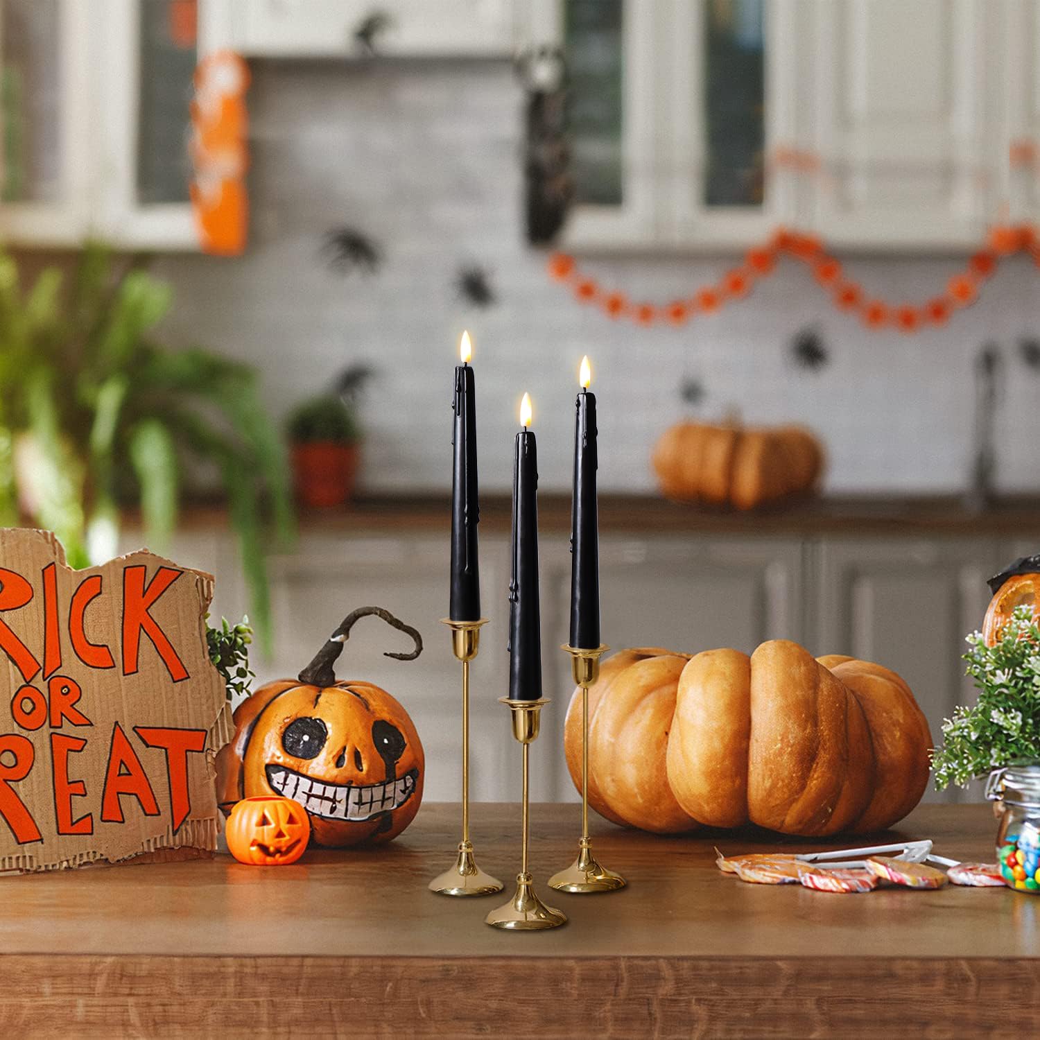 Stmarry candles on dining table illustrate chic Halloween decor.