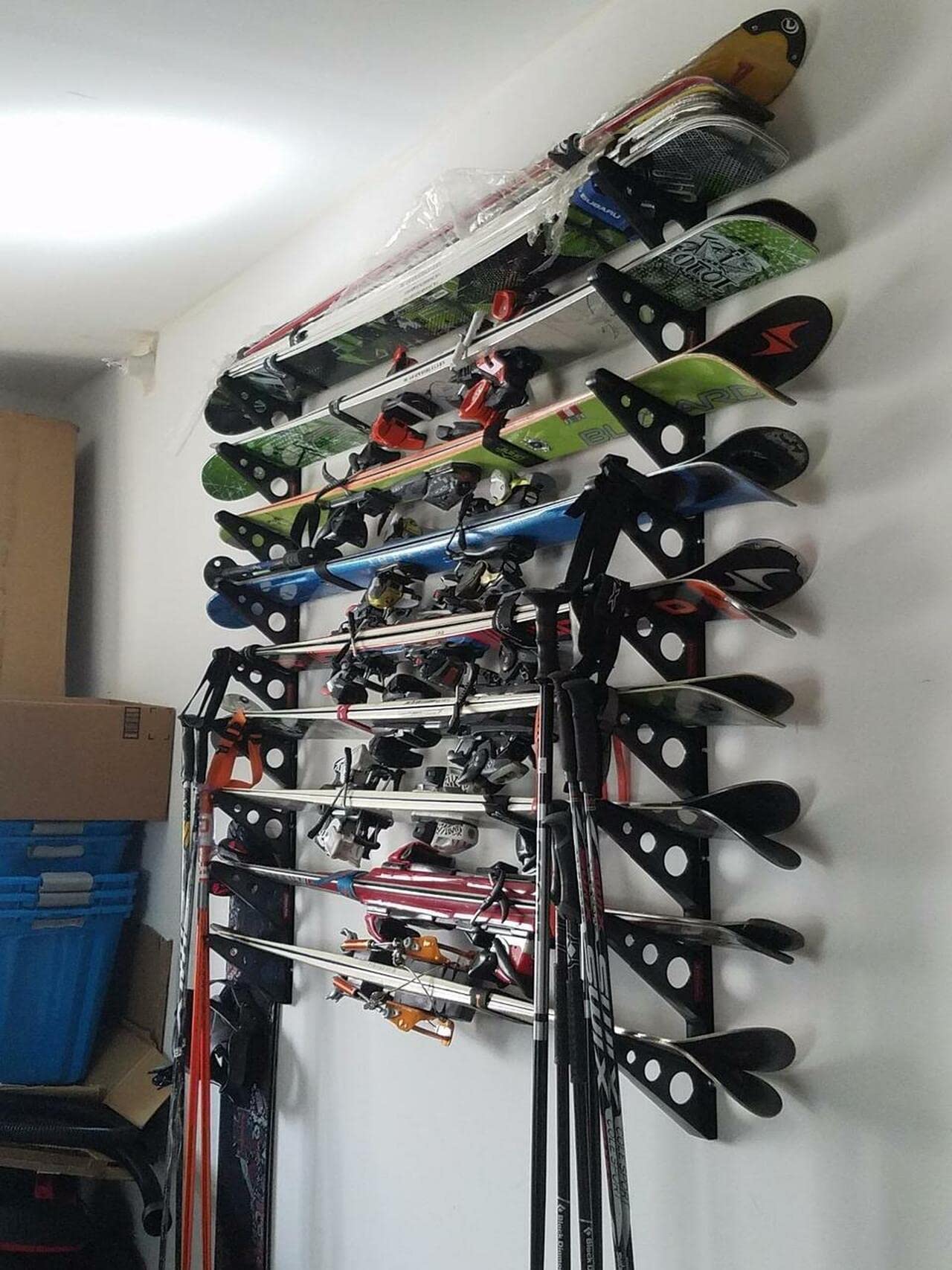 StoreYourBoard snowboard wall mount saving garage space while keeping equipment ready for next ride.