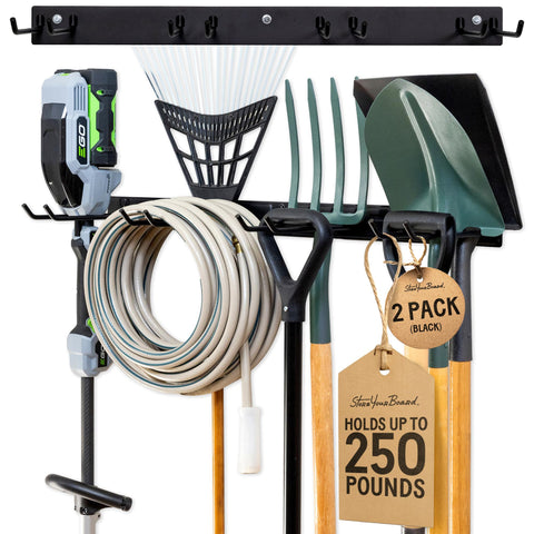 StoreYourBoard wall-mounted rack with four hooks keeps shovels and rakes off the floor for quick access.