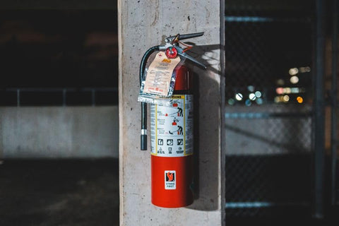 Strike First extinguisher in office setting emphasizes quick access.