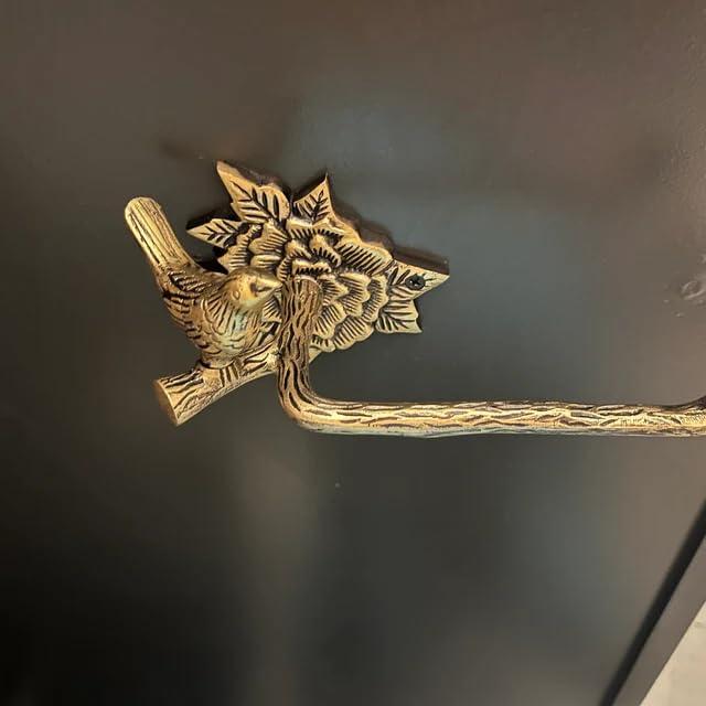 Stylentdecor brass bird toilet paper holder in a vintage bathroom scene.