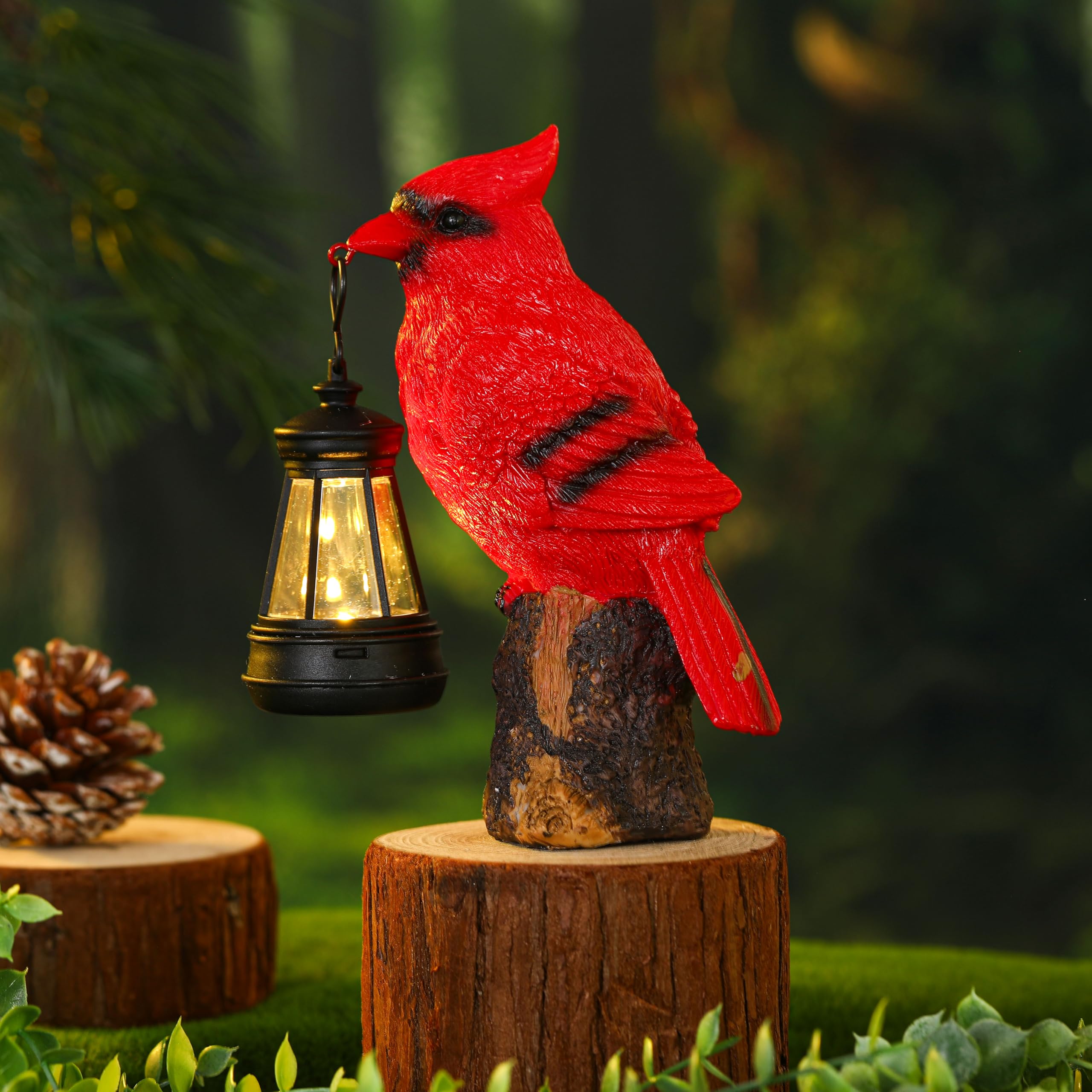 Suzile cardinal garden statue-solar lantern along garden bed at night