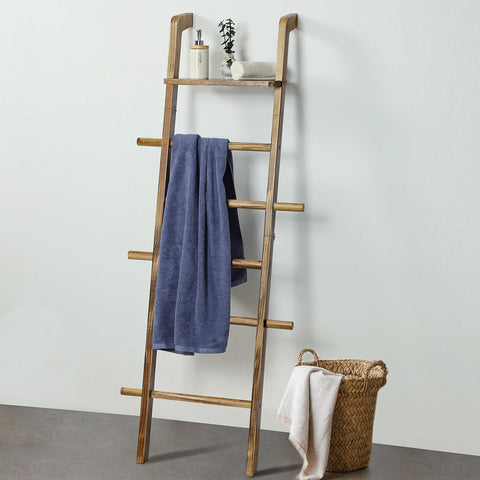 Taozun ladder decorated with holiday throws and ribbons for ambiance.