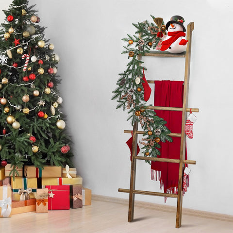 Taozun wall-leaning display holds blankets, towels, and small greenery.