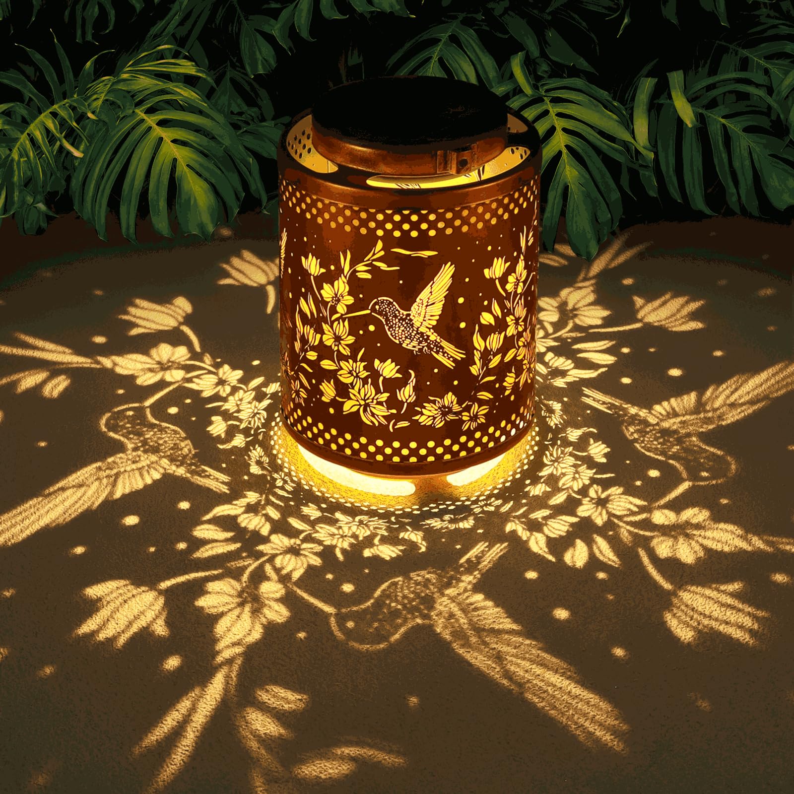 Tepaken hummingbird lantern in gold metal for ambient garden lighting.