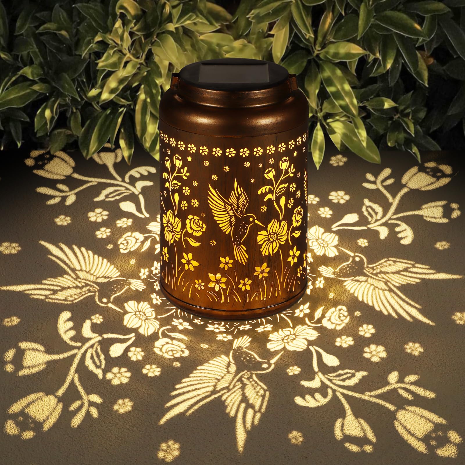 Tepaken solar lantern with hummingbird pattern hanging design provides warm garden ambiance.