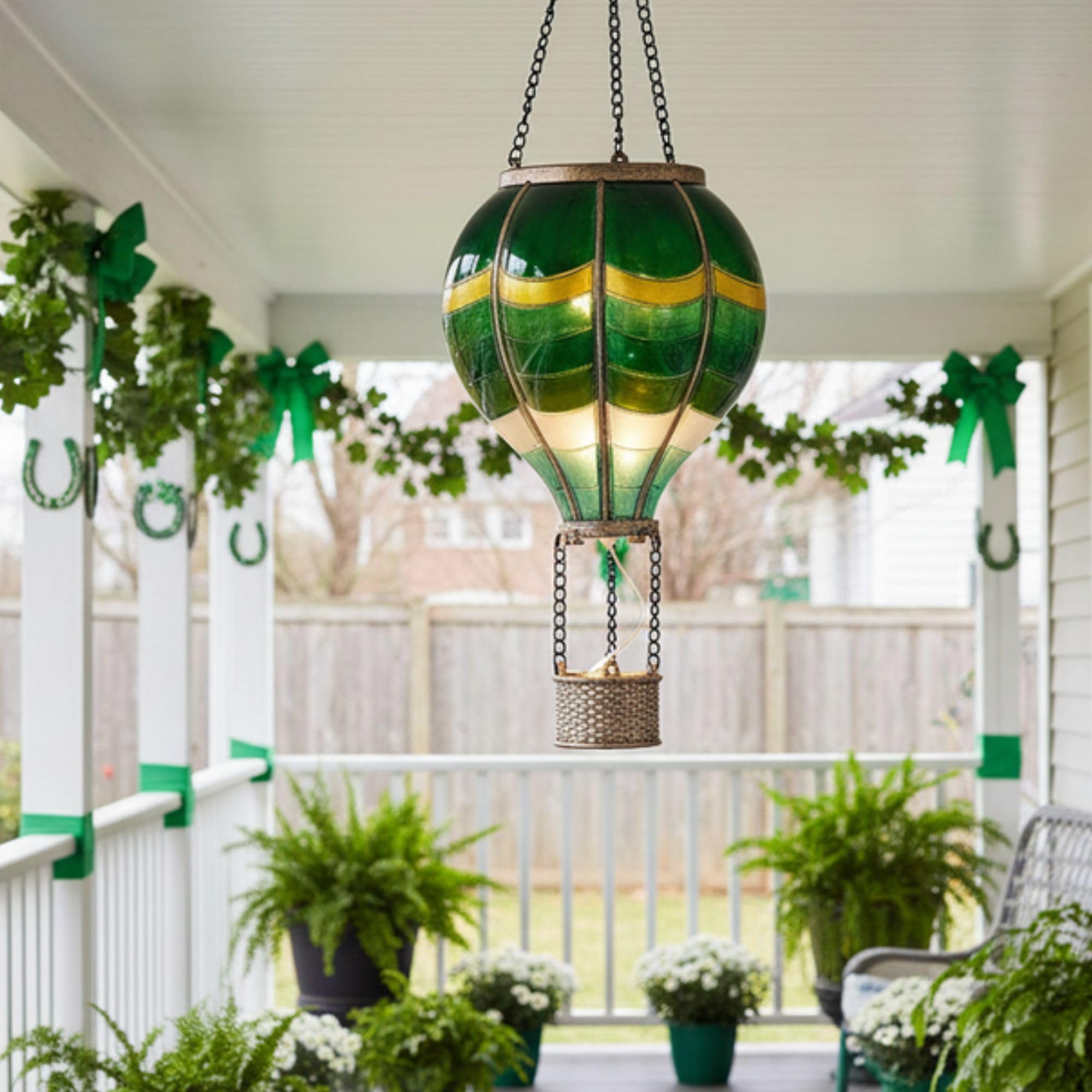 TERESA'S COLLECTIONS green hot air balloon lantern glows softly at dusk